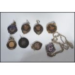 A group of eight silver hallmarked fob medals one being on an albert chain. Fobs to include
