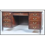 A 20th century French Empire revival twin pedestal mahogany office desk being raised on turned