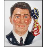 A Royal Doulton character jug depicting President Ronald Reagan, handle modelled as the the American