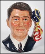 A Royal Doulton character jug depicting President Ronald Reagan, handle modelled as the the American