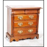 A 19th century walnut miniature chest of drawers apprentice piece having three drawers with brass