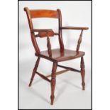 A 19th Victorian oxford bar back Windsor dining chair raised on turned legs with panel seat having