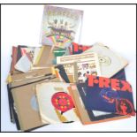 A collection of 45rpm 7" vinyl record singles and EP's featuring various artists and genres to
