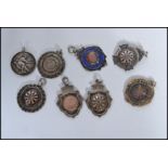 A group of eight silver hallmarked fob medals one being on an albert chain. Fobs to include darts
