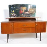 A retro mid century Danish influence teak wood dressing table being raised on squared legs with a
