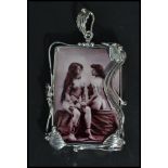 A large sterling silver panel necklace pendant having an inset erotic scene of two ladies. Weighs 24