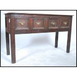 An 18th century Jacobean oak moulded front dresser base of small proportions. Raised on squared legs