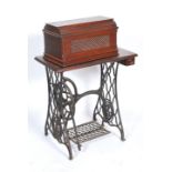 A late 19th century Victorian sewing machine and treadle table. The sewing machine base being