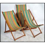 Hatherley - A group of three retro 1960's folding teak deck chairs each having stripped material