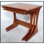 A set of three vintage 20th century Danish influence teak nest of tables in the manner of G-Plan.