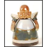 A Doulton salt glazed stone wear inkwell and cover modelled as a baby. Impressed marks to base 6985.