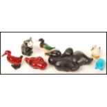 A group of Royal Doulton animals to include two Flambe duck a black cat , a black duck figurine