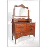 An Edwardian mahogany dressing table chest being raised on turned legs with short and deep drawers