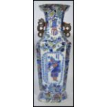 A 19th century Chinese vase having blue and white decoration of birds with dragon handles to