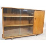 A mid century oak display cabinet bookcase room divider in the manner of Ercol, believed to be