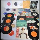 Vinyl Records - A large collection of vinyl 7" single records dating from the 1960's featuring