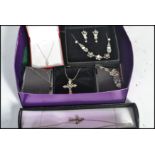 A group of vintage silver necklaces and pendants to include crucifix , flowers , white stone , heart