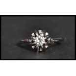 A white gold single stone diamond ring. The central stone of approx 25 points in a large prong
