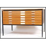 A retro 1970's architects teak wood affect plan chest of six drawers, slab top raised on square