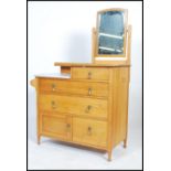 A 1930's Waring & Gillows solid oak and marble dressing table / chest of drawers having an