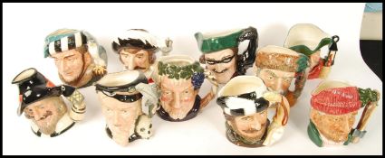 A group of four Royal Doulton character jugs to include The Falconer D6533 , The Trapper D6609 ,