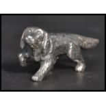 A sterling silver figurine in the form of a dog. Weighs 12 grams.