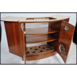 A vintage retro 20th century walnut bar cocktail cabinet by Turnidge of London having a fold out