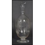 A 19th century Victorian hand blown cut glass decanter raised on a circular foot with hand