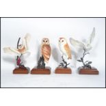 A group of four highly detailed still life models of owls to include barn owl , tawny owl etc. All