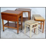 A retro mid century teak wood butlers serving trolley of Danish influence together with a set of 3