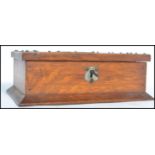 A 1920's oak table lidded cigarette box of rectangular form having pressed metal decoration and a