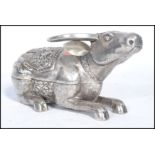 A Chinese silver lidded pot in the form of an Ox / Cow modelled in a seated position having a