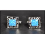 A pair of sterling silver and opallite panel cuff links of square form having pierced sides and T