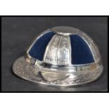 A sterling silver pin cushion in the form of a vintage school hat. Weighs 19 grams.