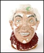 A Royal Doulton character jug entitled 'The Clown', having white hair and multicoloured handle,
