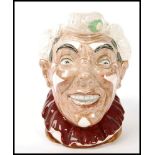 A Royal Doulton character jug entitled 'The Clown', having white hair and multicoloured handle,