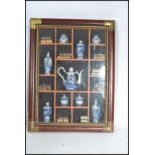 A vintage 20th century antique style framed and glazed display of miniature Chinese wares to include