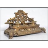 A Victorian 19th century cast brass desk tidy inkwell having twin wells with gallery back, the whole
