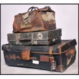 A collection of early 20th century luggage to include a large canvas and leather bound trunk,