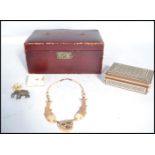 A collection of early 20th century items to include a bone necklace with a central heart shaped