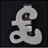 A sterling silver money clip in the form of a pound sign. Weighs 20 grams.