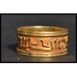 An Egyptian 18ct gold band ring having the Zodiac symbols around the band. Weighs 8.6 grams size