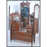 An Edwardian walnut drop centre bat wing dressing table. Raised on turned legs with castors having a