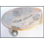 A 19th century Chinese silver and mother of pearl salt / trinket dish raised on three ball feet with