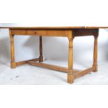 A large 20th century good quality country oak refectory dining table being raised on turned legs