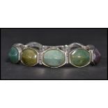 A sterling silver panel bracelet set with agates having a fold over clasp. Weighs 50 grams.