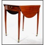 An early 20th century Edwardian mahogany occasional drop leaf table, raised on square tapering