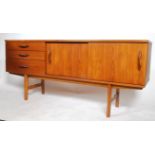 A Danish inspired 1960's retro teak wood sideboard having three drawers adjacent to a twin sliding