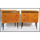 A matching pair of vintage 20th century small chest of drawers raised on tapering ebonised legs. The