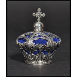 A sterling silver pin cushion in the form of a crown having a scrolled foliage design. Weighs 42